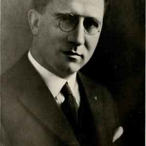 Moderne Tom Carruth eettafel met glazen blad en zwarte metalen poten.